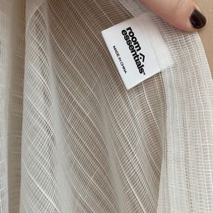 Three white sheer curtain panels